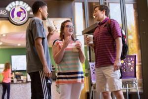 Photo of students at Gilbert's Coffee Shop in front of Richardson Library at HSU.